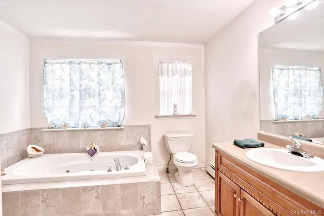 a bathroom with a tub sink and glass door