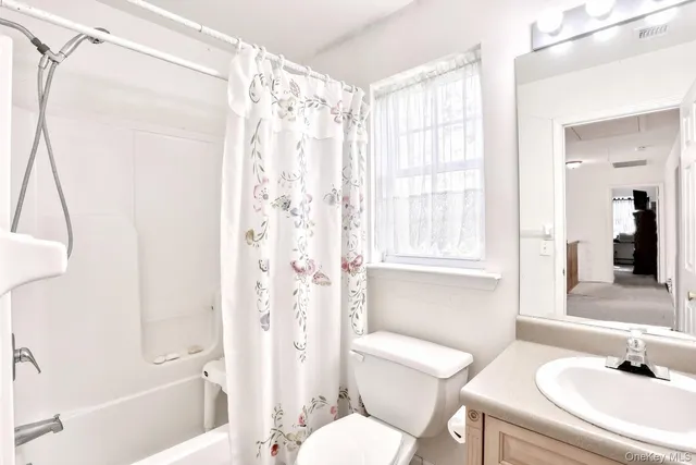 a front view of a house with plants