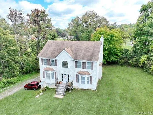 a aerial view of a house with yard and a garden