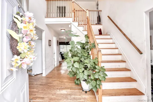 a view of a hallway with wooden floor and potted plants