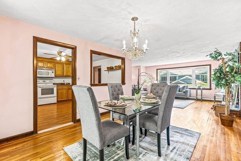 7-9 Cleveland Road Winchester, MA 01890 - Photo 8 of 38 a view of a dining room with furniture a chandelier and wooden floor