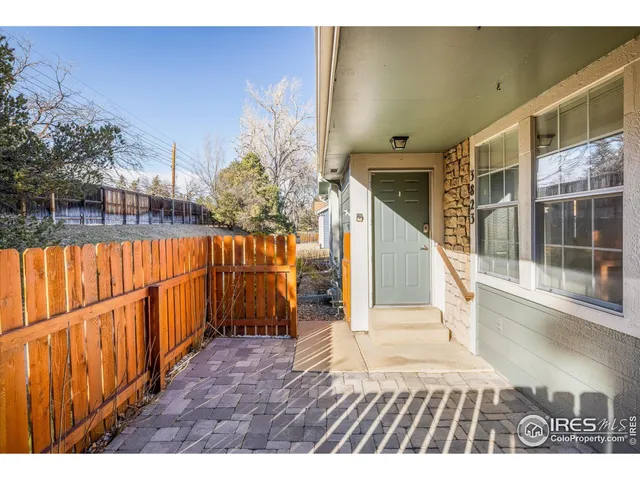 a view of balcony with wooden floor and fence