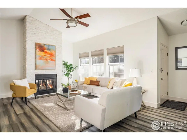 a living room with furniture a fireplace and a table
