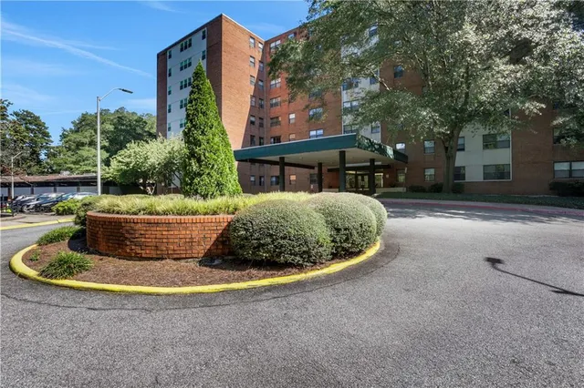 a view of a small house with potted plants