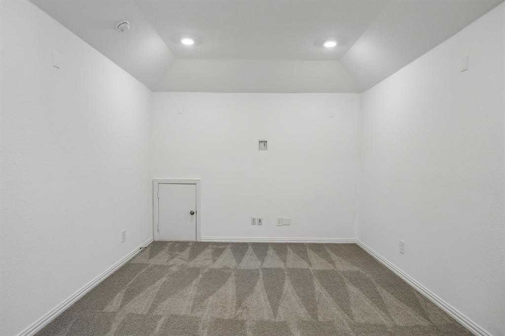 1303 Wheelwright Drive Forney, TX 75126 - Photo 29 of 39 Recessed lighting illuminating a spacious room with patterned carpeting