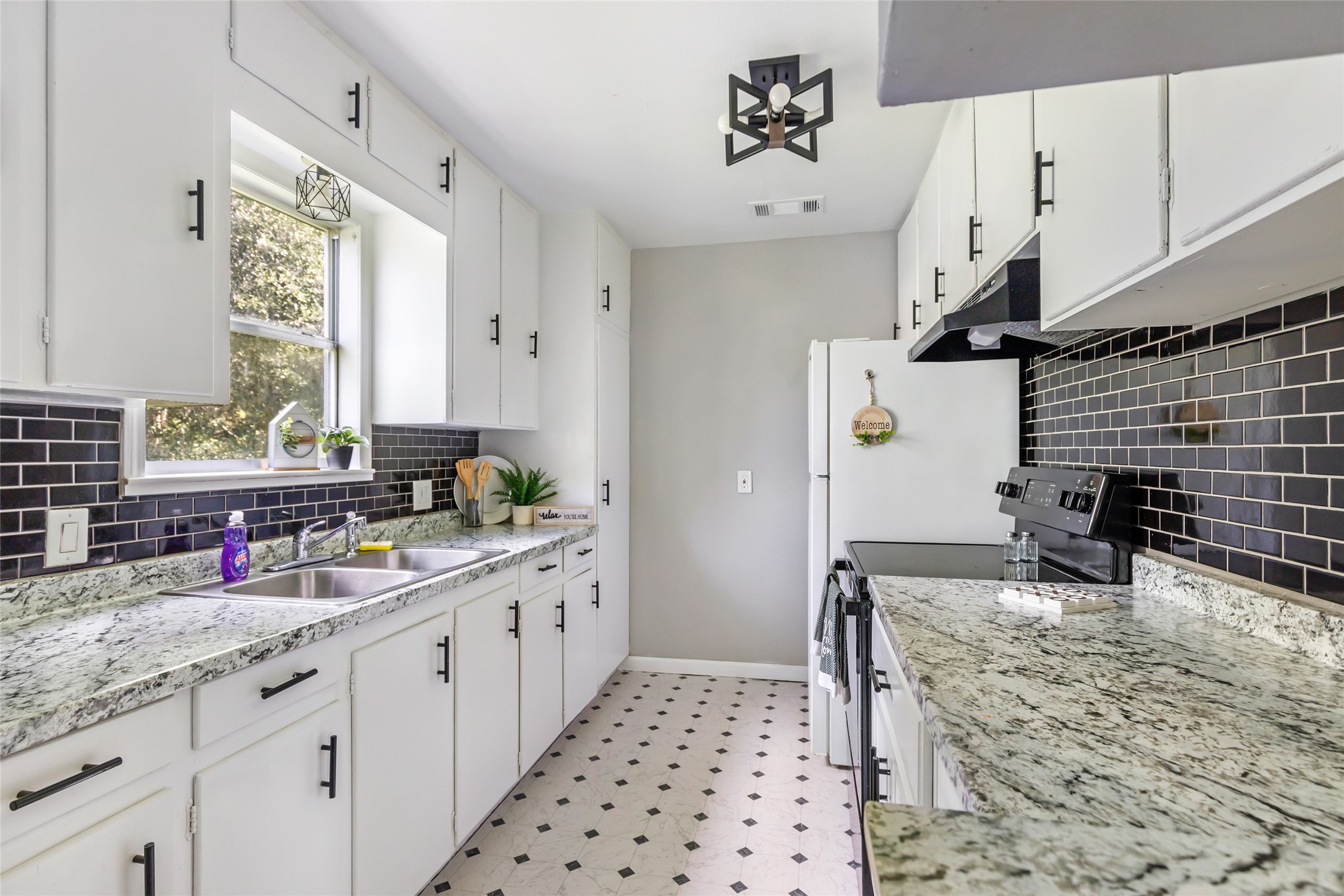26864 Morgan Cemetery Road Cleveland, TX 77328 - Photo 24 of 26 a kitchen with granite countertop a sink cabinets and window