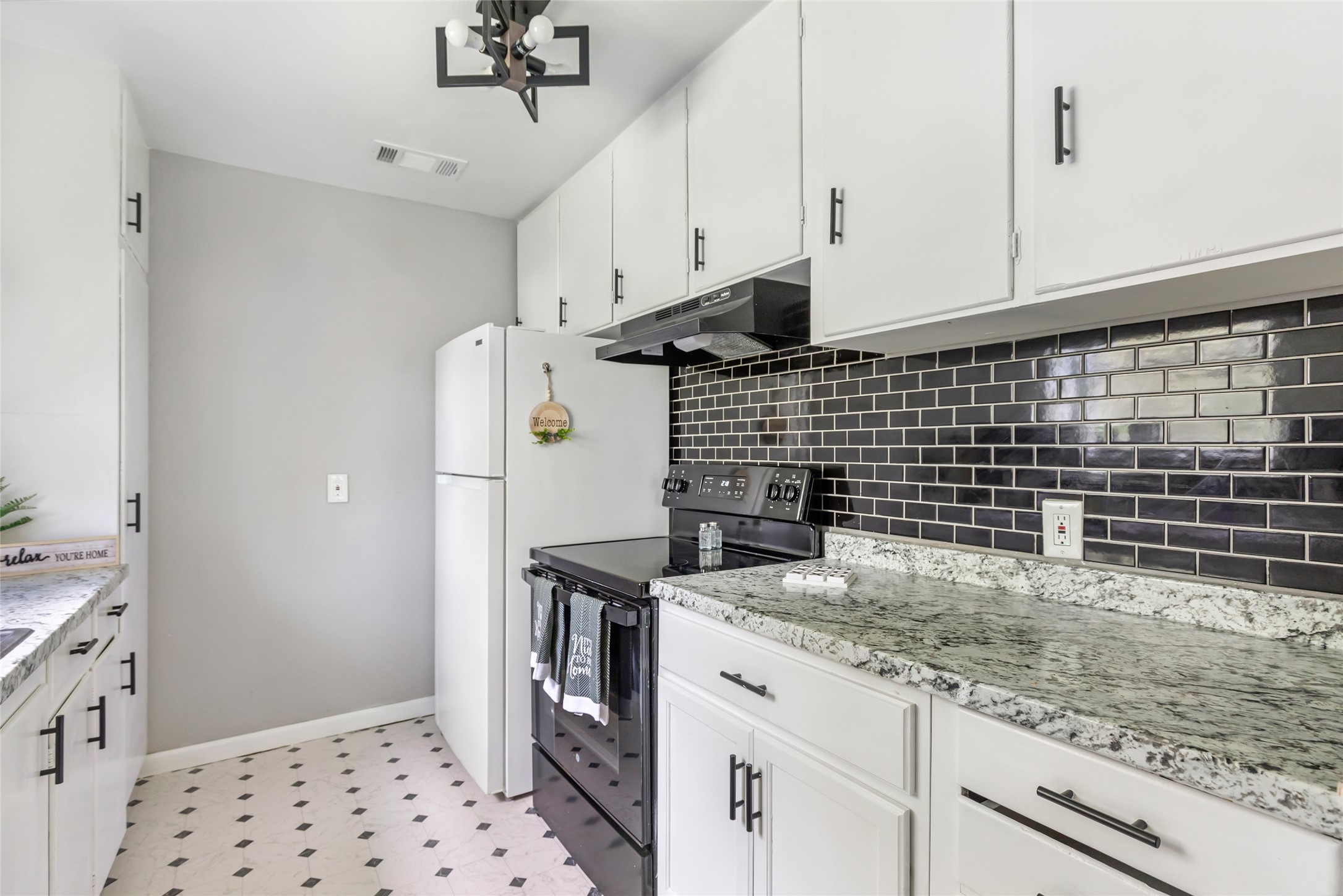 26864 Morgan Cemetery Road Cleveland, TX 77328 - Photo 25 of 26 a kitchen with granite countertop a sink a stove and refrigerator