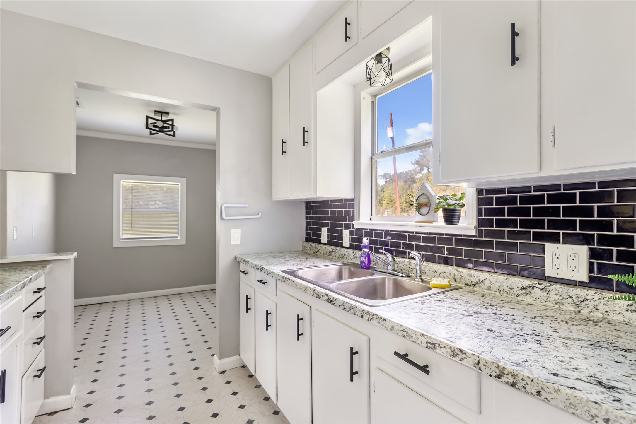 26864 Morgan Cemetery Road Cleveland, TX 77328 - Photo 26 of 26 a kitchen with a sink a stove a counter space and cabinets