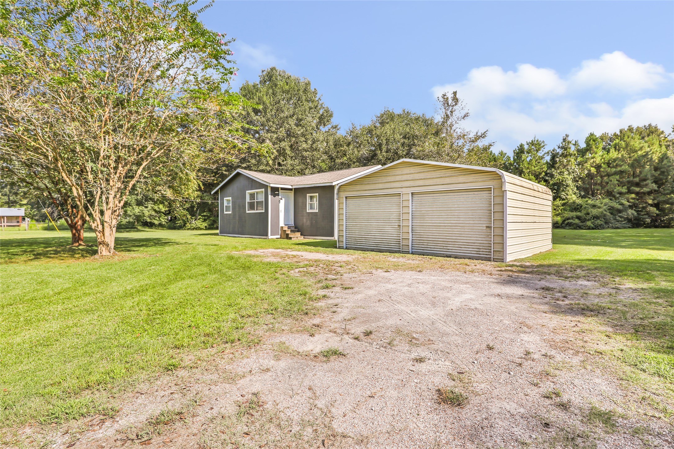 26864 Morgan Cemetery Road Cleveland, TX 77328 - Photo 3 of 26 a front view of a house with a garden and tree