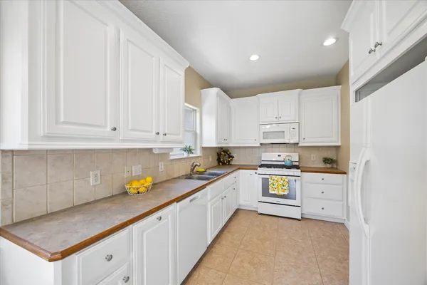 a kitchen with a sink cabinets and window