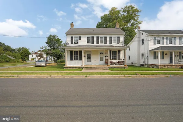 a front view of a house with a garden and plants