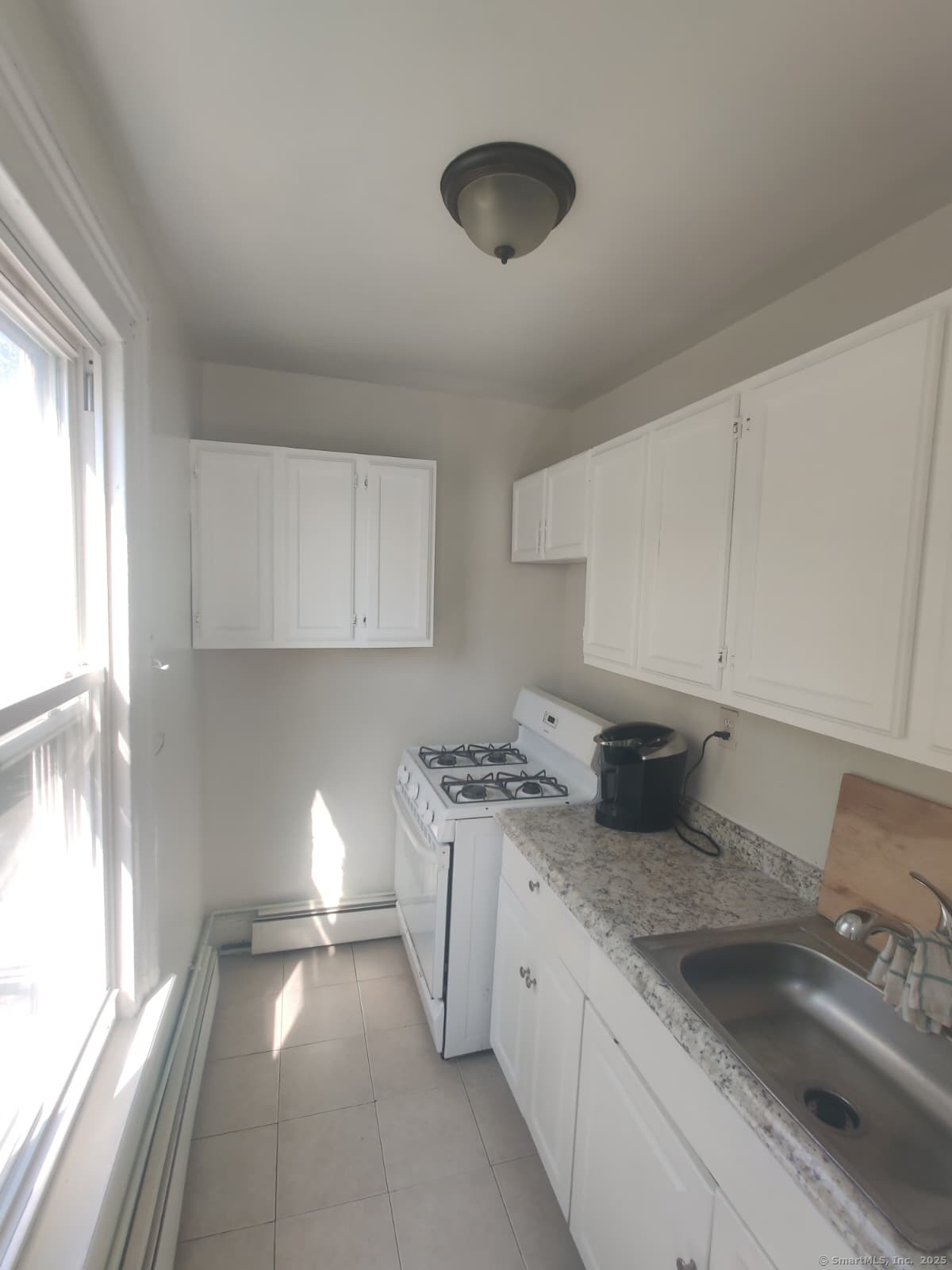 322 Catherine Street Bridgeport, CT 06604 - Photo 12 of 28 a kitchen with stainless steel appliances granite countertop a sink stove and cabinets