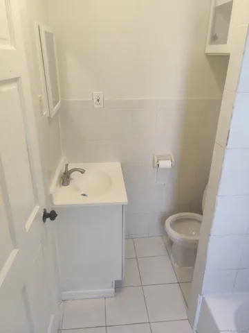 a bathroom with a sink toilet and mirror