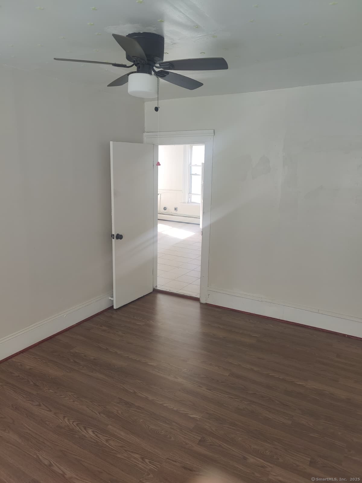 322 Catherine Street Bridgeport, CT 06604 - Photo 22 of 28 an empty room with wooden floor ceiling fan and windows