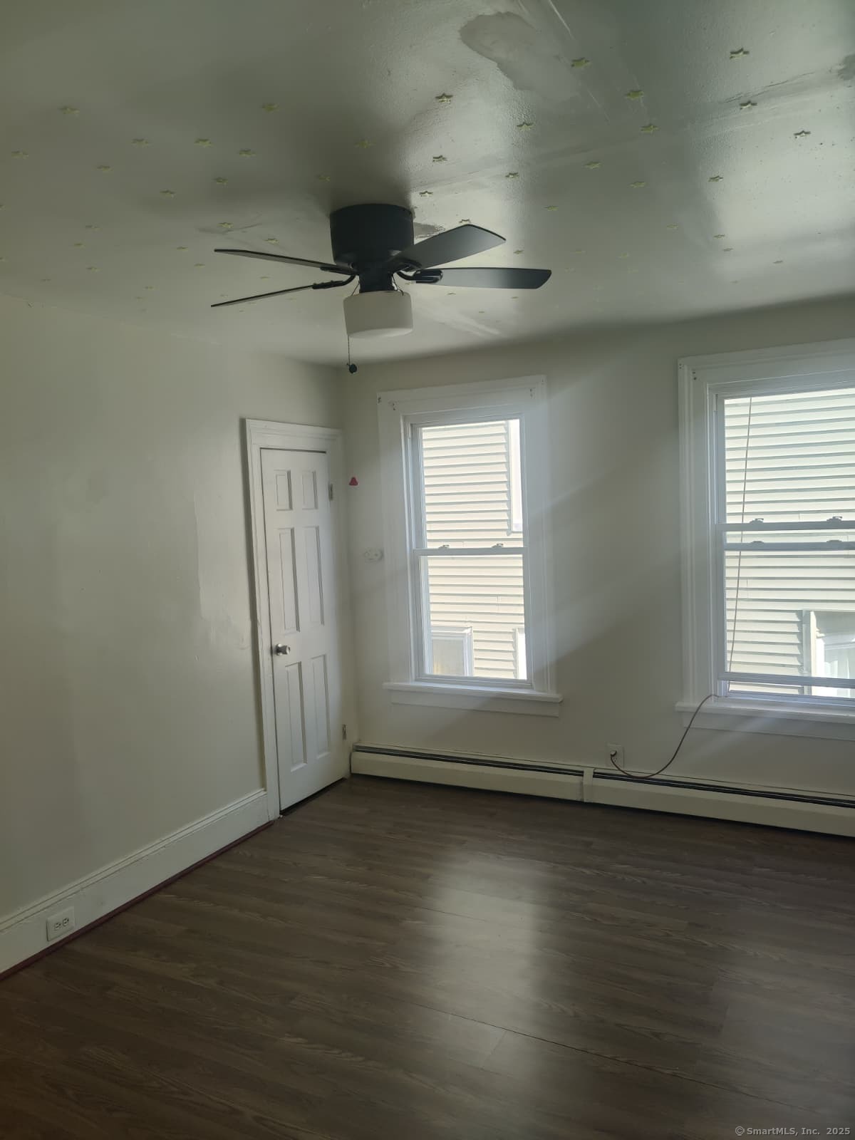 322 Catherine Street Bridgeport, CT 06604 - Photo 23 of 28 an empty room with wooden floor and windows
