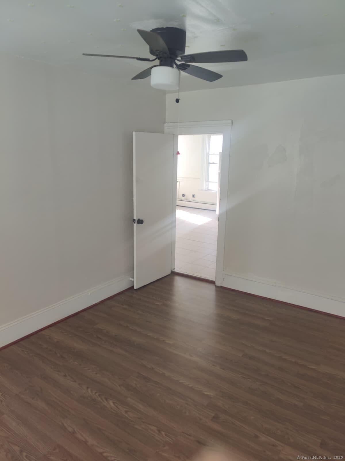 322 Catherine Street Bridgeport, CT 06604 - Photo 24 of 28 a view of an empty room with a window and wooden floor