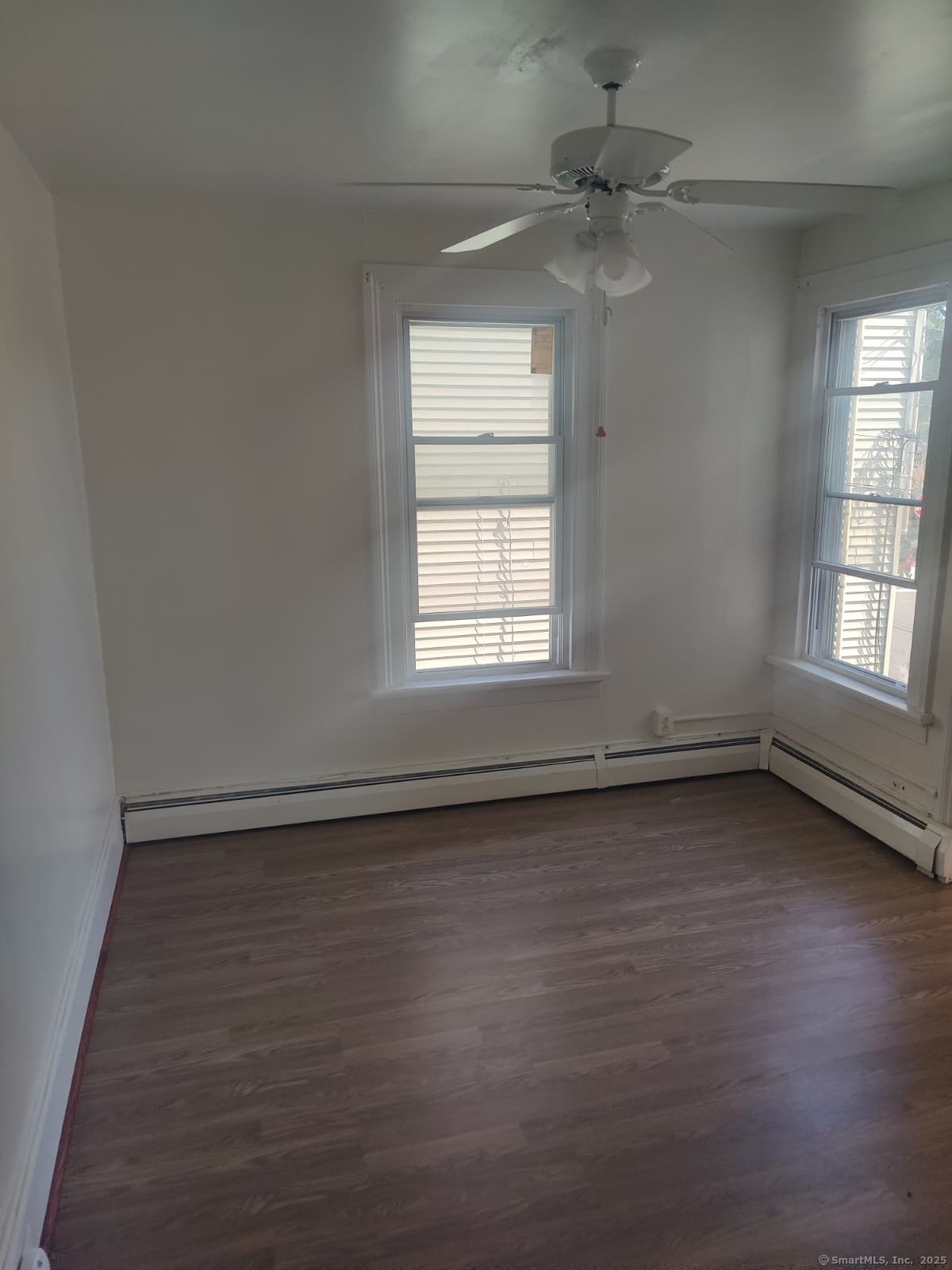 322 Catherine Street Bridgeport, CT 06604 - Photo 25 of 28 an empty room with wooden floor and windows