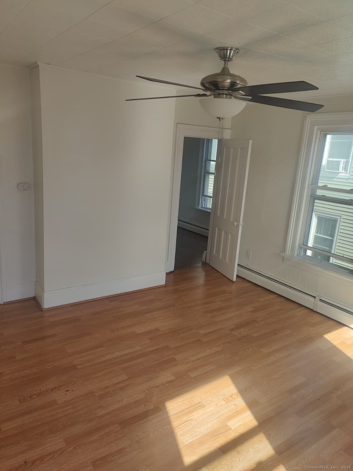 322 Catherine Street Bridgeport, CT 06604 - Photo 28 of 28 a view of a big room with wooden floor and windows