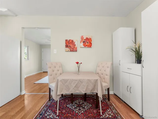 a view of a room with furniture and wooden floor