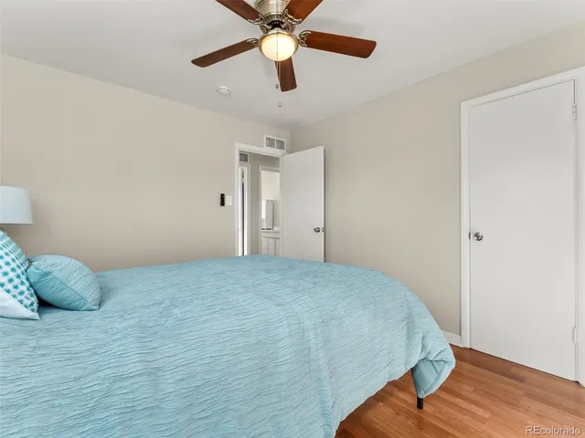 a bedroom with a bed and a ceiling fan