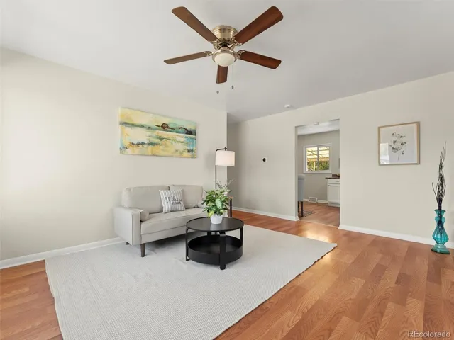 a living room with furniture and wooden floor