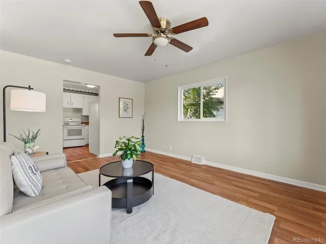 a living room with furniture and a potted plant