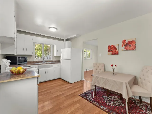 a kitchen with a refrigerator and a stove top oven