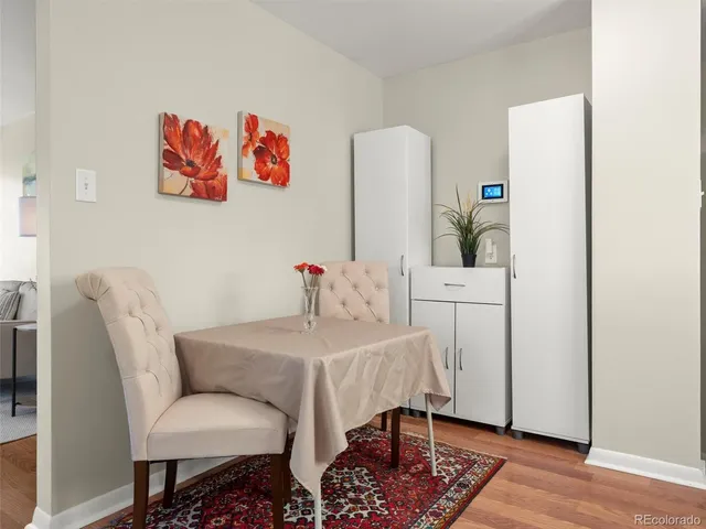 a dining room with furniture and wooden floor