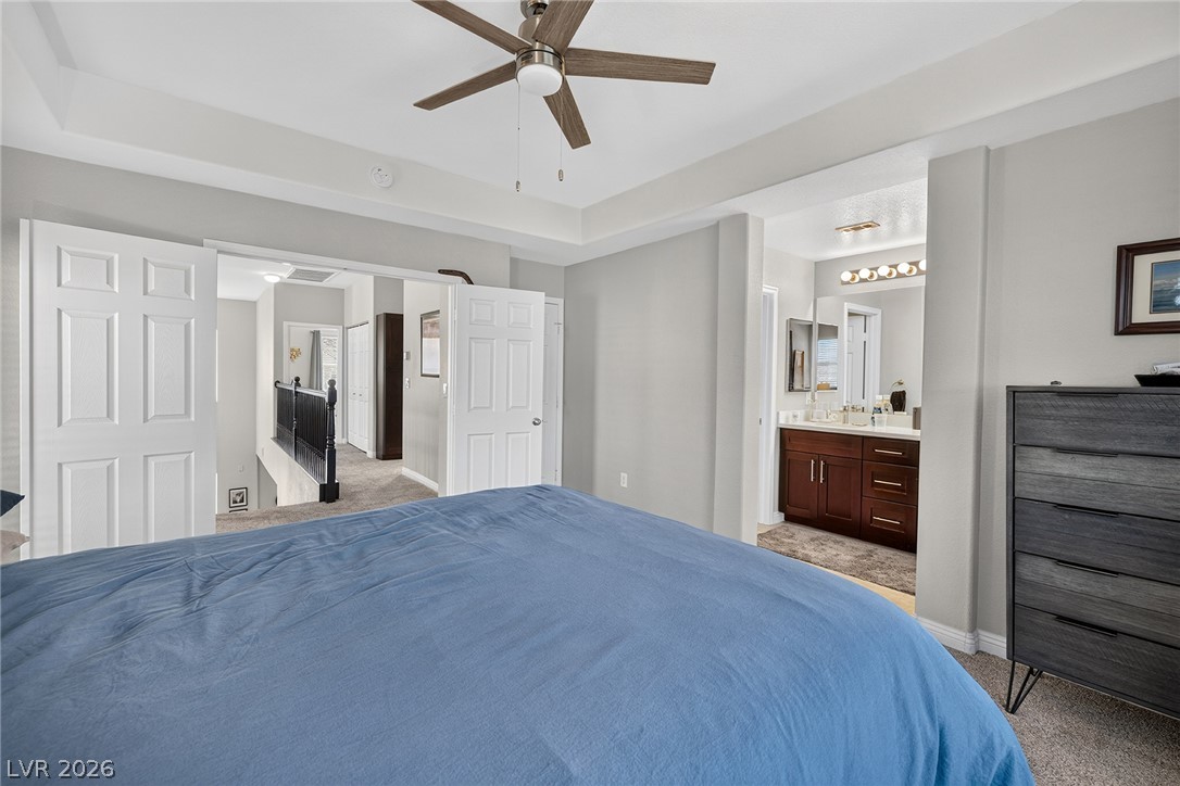 226 Priority Point Street Henderson, NV 89012 - Photo 22 of 32 Plush carpeting and a classic tray ceiling highlight this comfortable master suite.