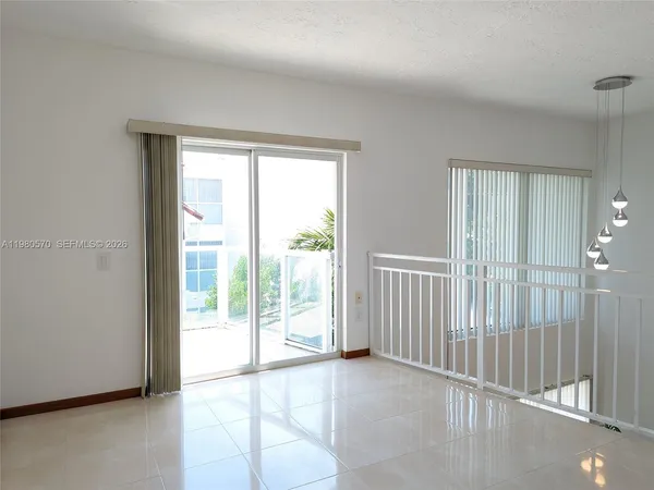 a view of an empty room with glass door