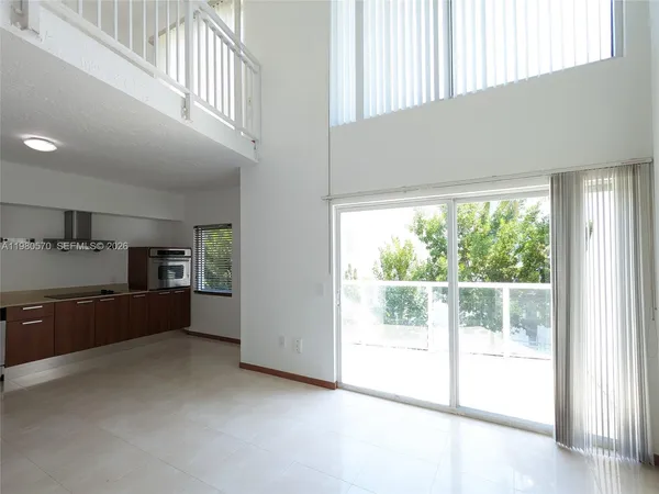 a view of a kitchen with a sink and dishwasher with wooden floor