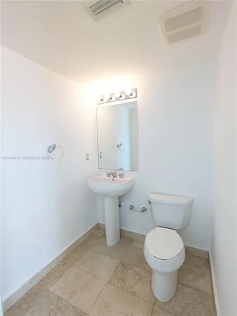a bathroom with a sink a toilet and mirror