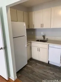 a white refrigerator freezer sitting inside of a kitchen