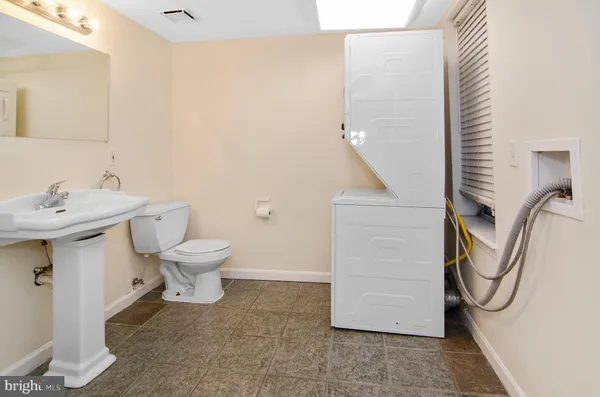 a bathroom with a sink a toilet and mirror