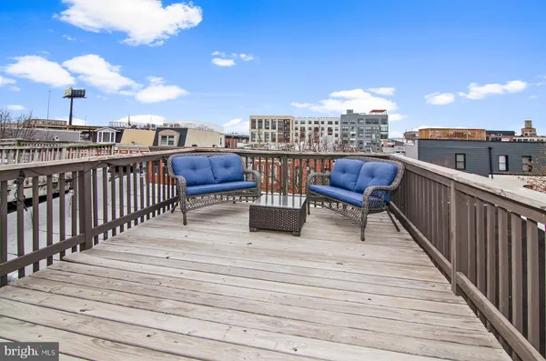 a view of a balcony with wooden benches