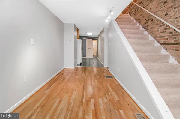 a view of a hallway with wooden floor