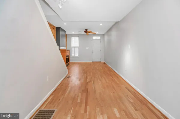 a view of a hallway with wooden floor
