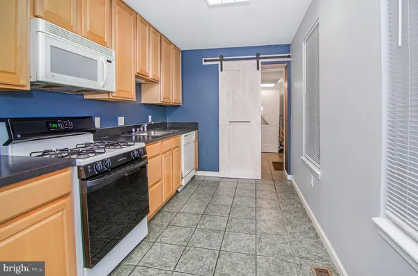 a kitchen with stainless steel appliances granite countertop a stove and a microwave