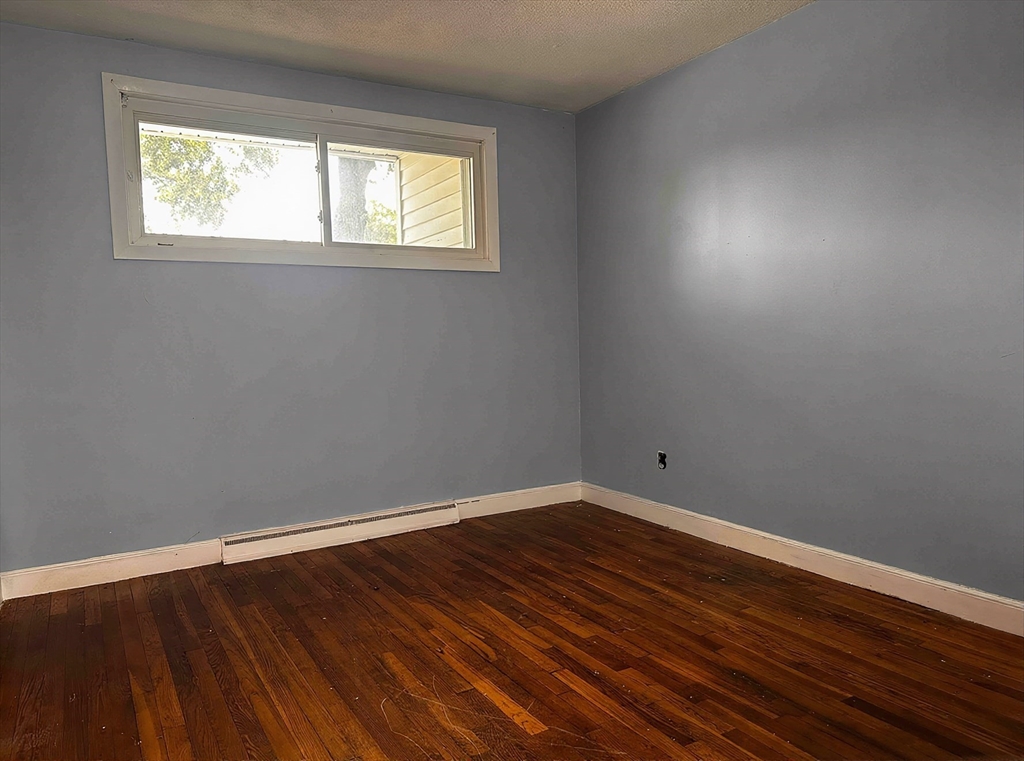 22 Corman Road Boston, MA 02126 - Photo 16 of 29 a room with wooden floor and window