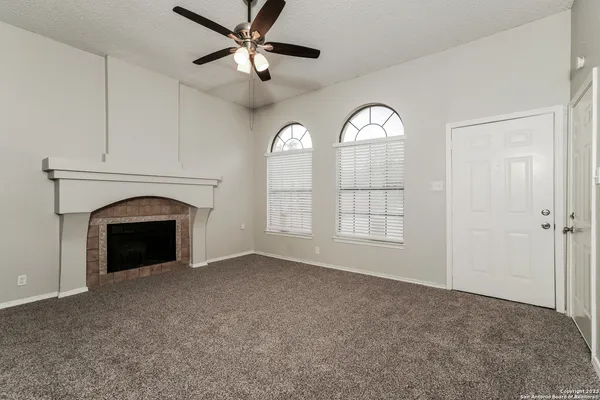 a view of empty room with windows and fireplace