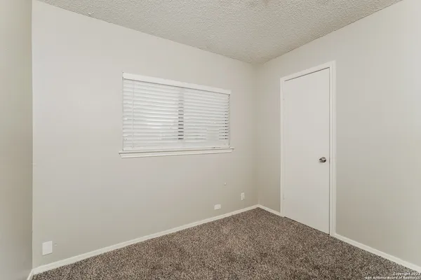 a view of an empty room with closet