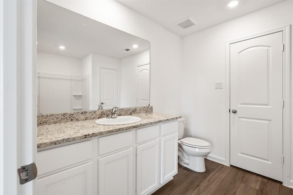 585 Aplite Pass Maxwell, TX 78656 - Photo 9 of 13 a bathroom with a granite countertop sink toilet and shower