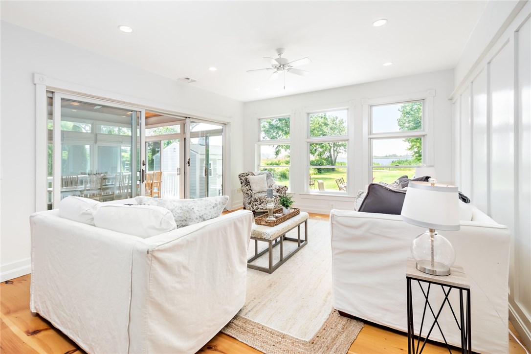 35 Lake Road Narragansett, RI 02882 - Photo 10 of 49 Enjoy the view from the living room with easy access to an oversized sunroom and outdoor patio