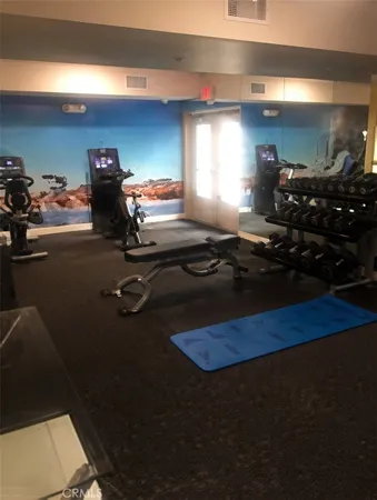 a room with gym equipment and a fireplace