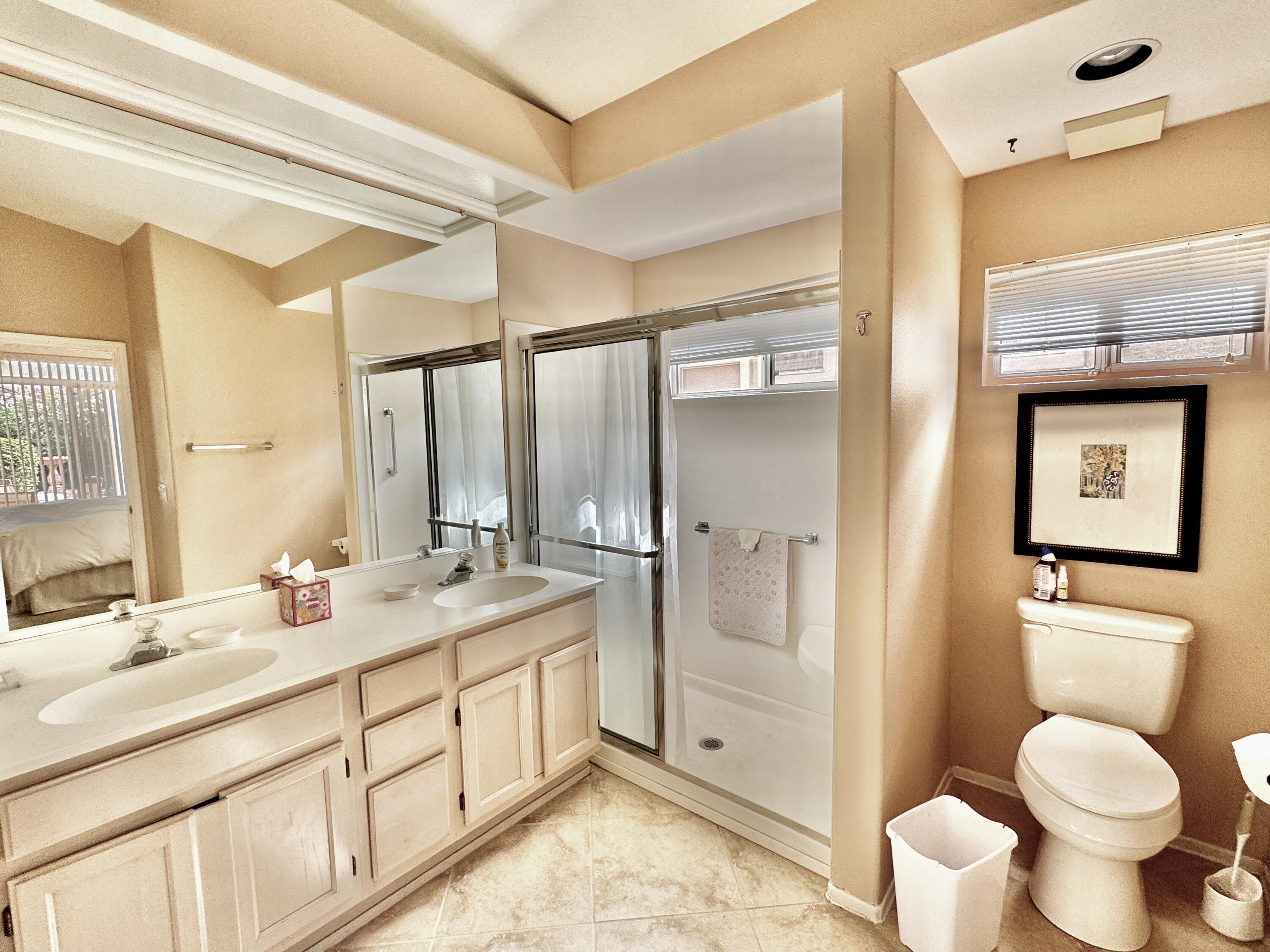 78376 Moongold Road Palm Desert, CA 92211 - Photo 9 of 36 a bathroom with a granite countertop toilet sink and mirror