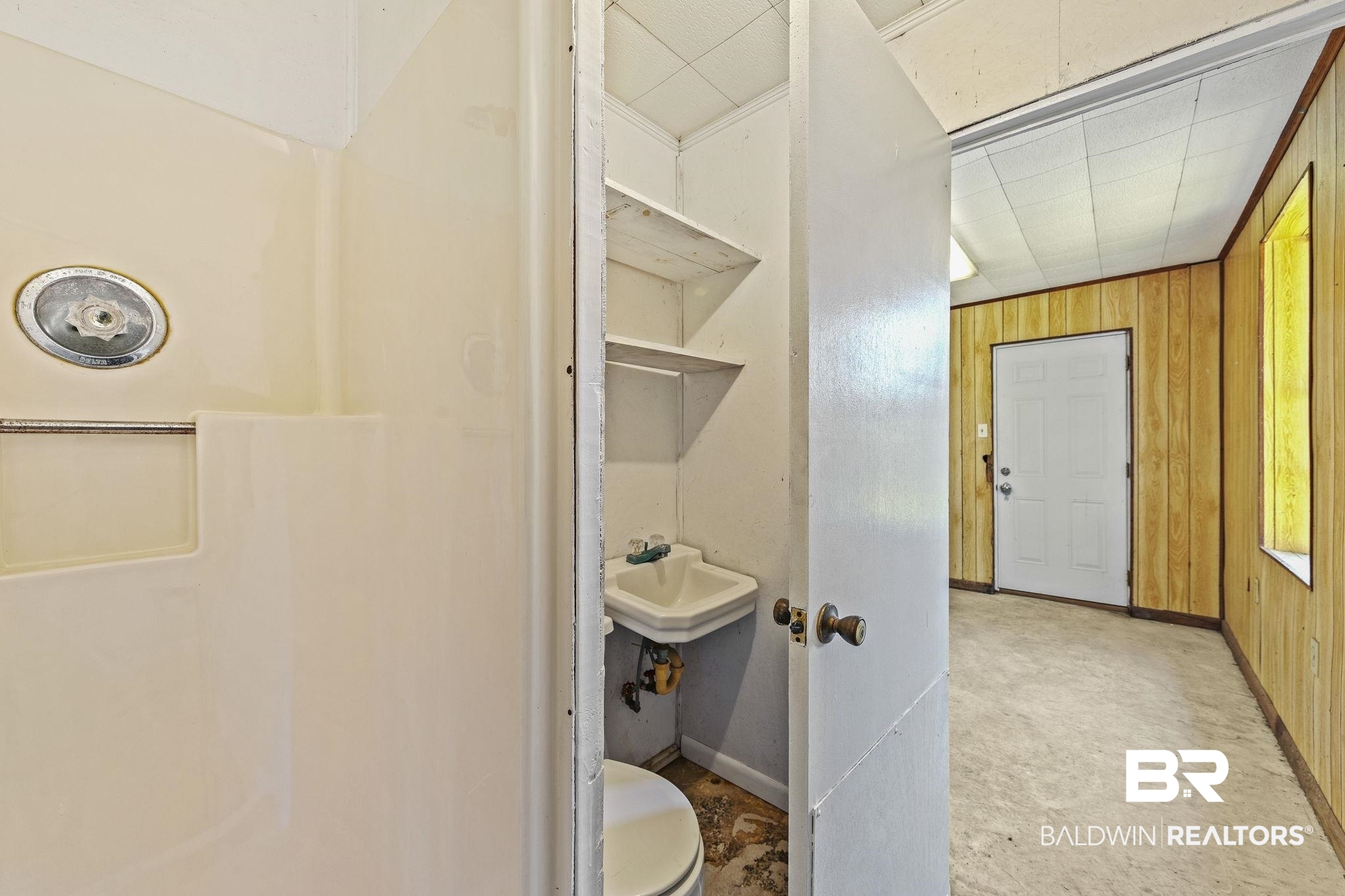 4366 Barden Avenue Mobile, AL 36619 - Photo 26 of 40 Bathroom with sink, wood walls, and toilet