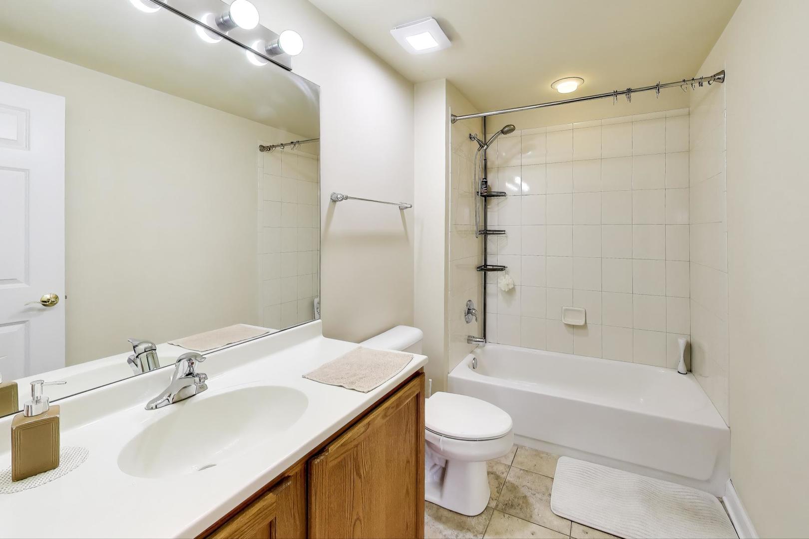 77 North Wolf Road, Unit 312 Northlake, IL 60164 - Photo 13 of 19 a bathroom with a sink toilet and shower