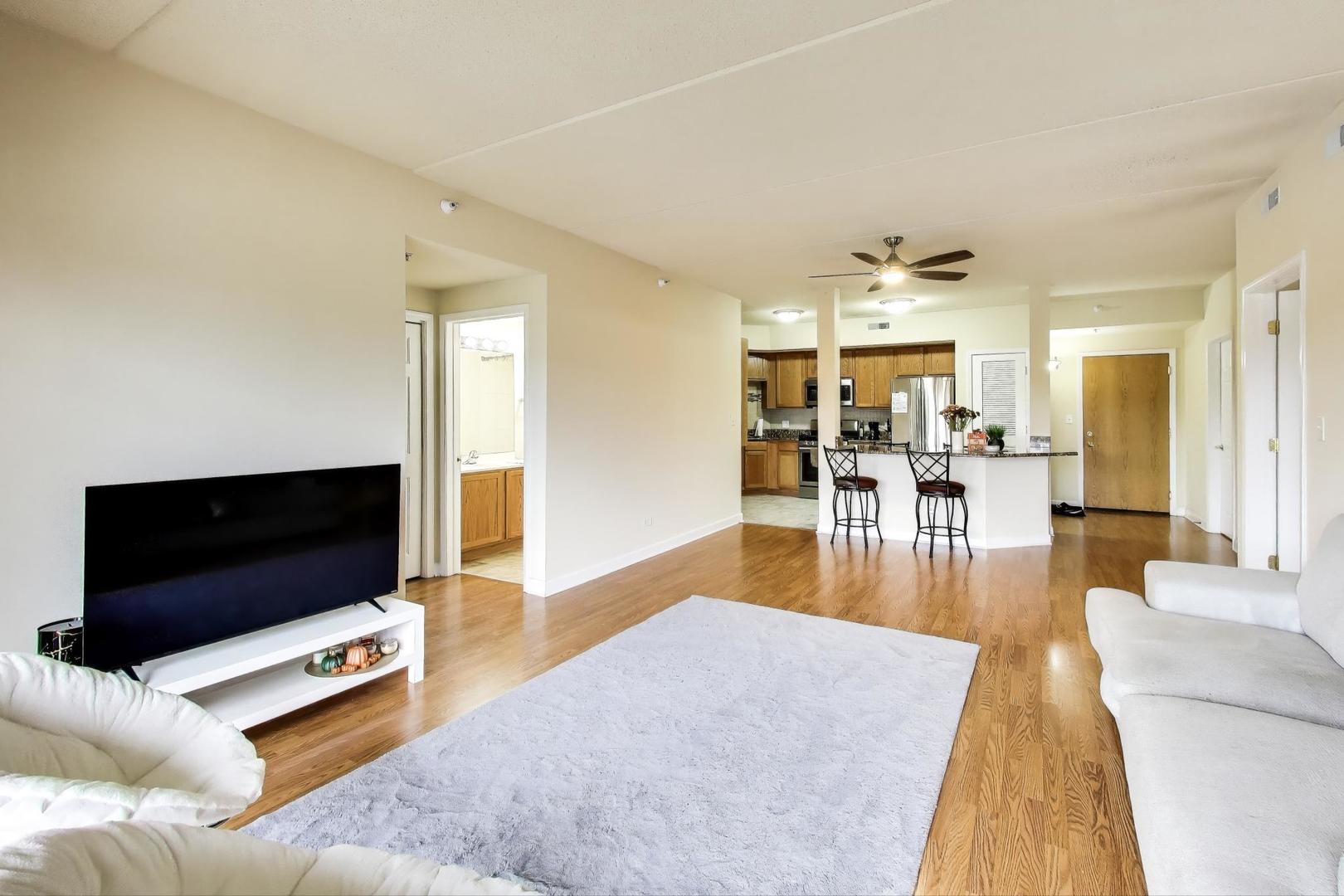 77 North Wolf Road, Unit 312 Northlake, IL 60164 - Photo 7 of 19 a living room with furniture and a flat screen tv