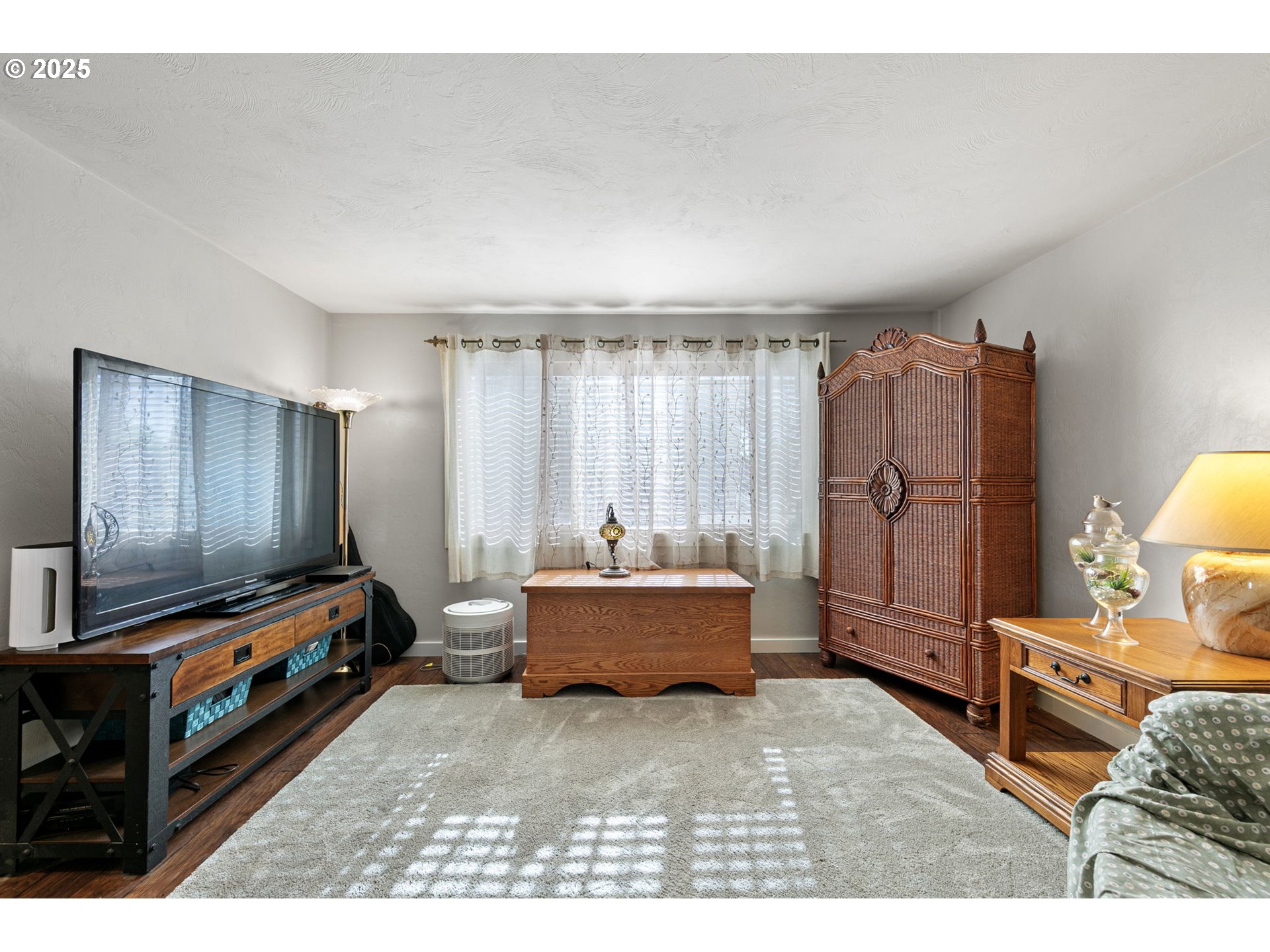 1011 Rose Street Junction City, OR 97448 - Photo 11 of 44 a living room with furniture and a flat screen tv