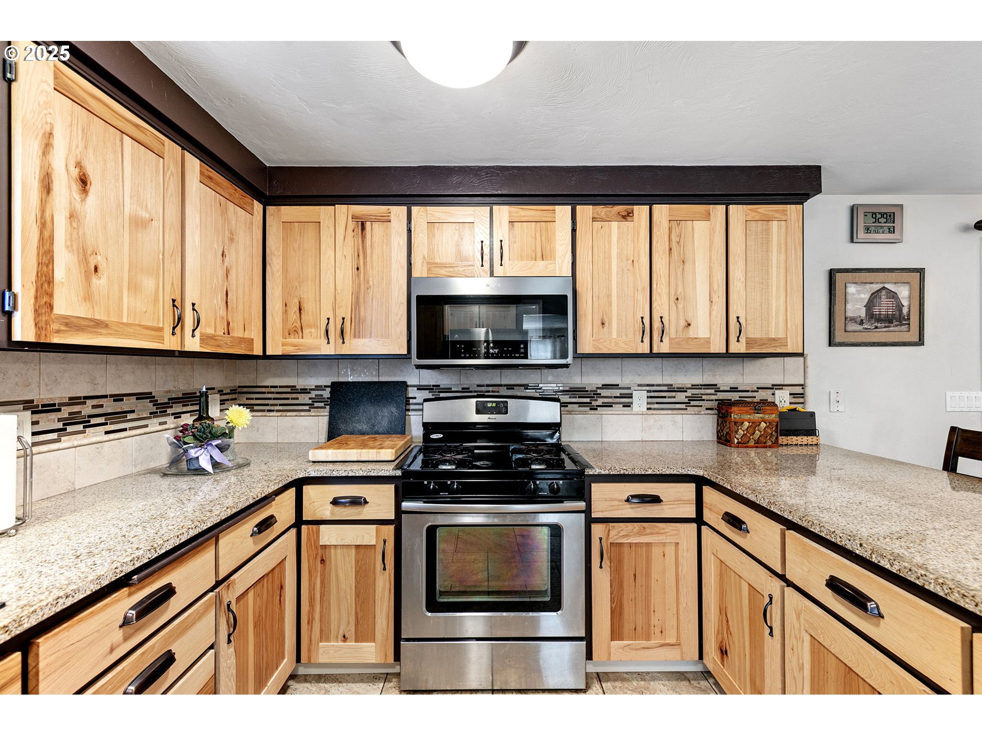 1011 Rose Street Junction City, OR 97448 - Photo 15 of 44 a kitchen with granite countertop a stove a sink and a microwave